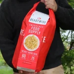 man holding a emergency food grab bag