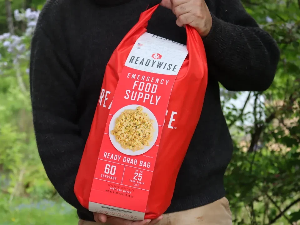 man holding a emergency food grab bag