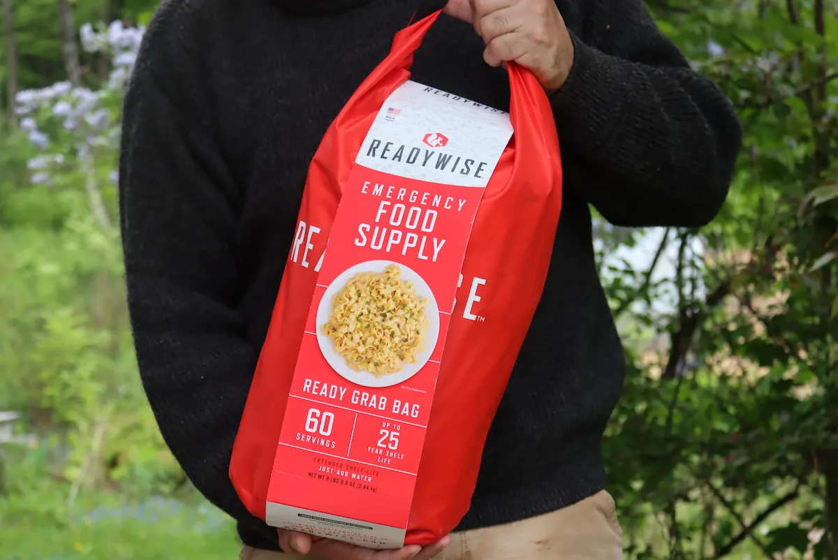 man holding a emergency food grab bag