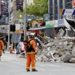 Search & rescue personnel with earthquake rubble.